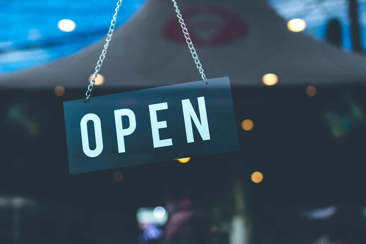 Open sign hanging on a window